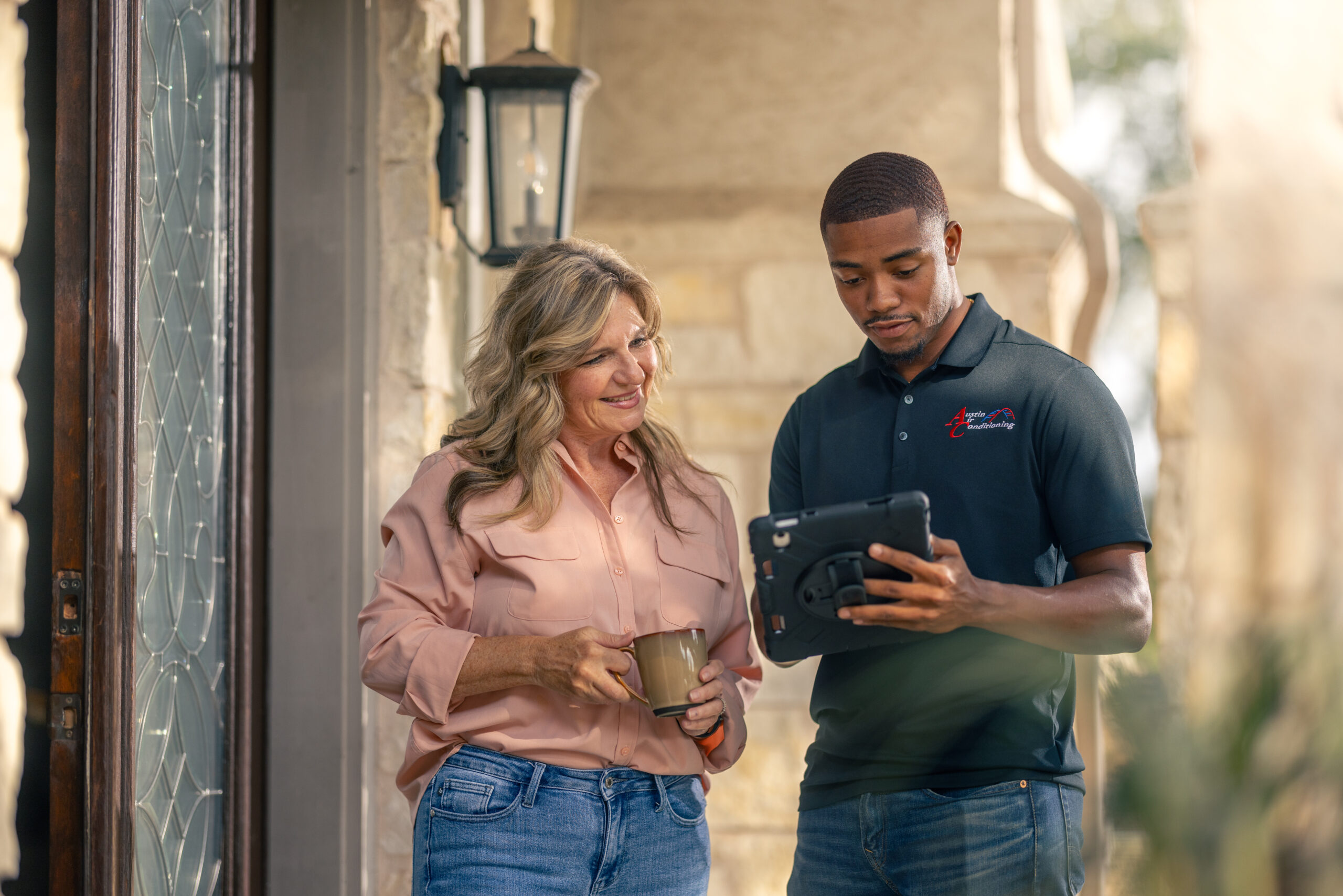 Technician walks through service plan with customer outside of home